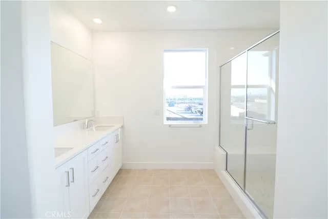 a bathroom with a double vanity sink and a window