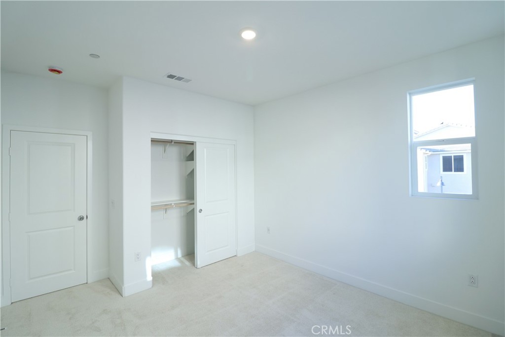 647 Gadwall Irvine, CA 92618 - Photo 20 of 29 an empty room with closet and wooden door