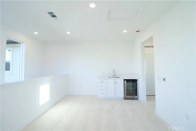 an empty room with a empty space and windows