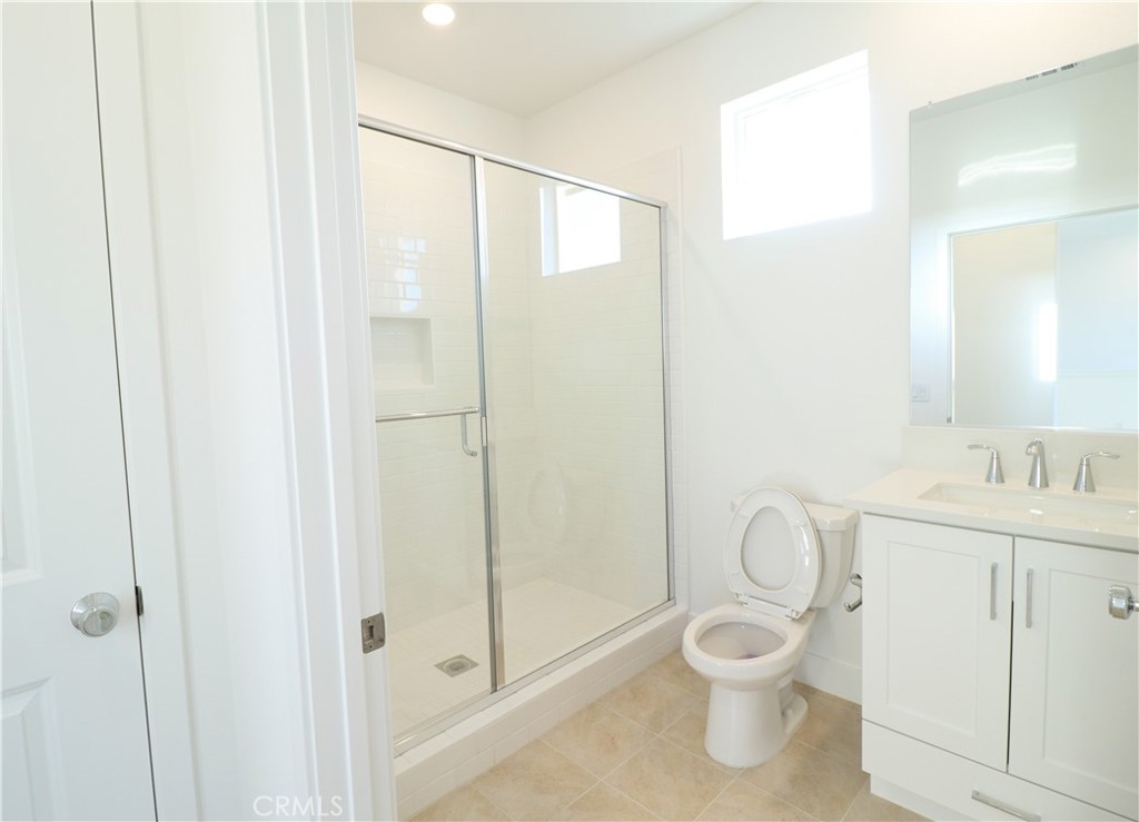 647 Gadwall Irvine, CA 92618 - Photo 26 of 29 a bathroom with a toilet shower vanity and a sink