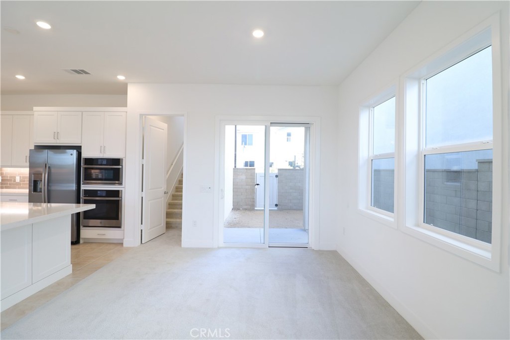 647 Gadwall Irvine, CA 92618 - Photo 3 of 29 a view of a kitchen with refrigerator and window