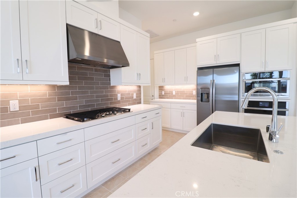 647 Gadwall Irvine, CA 92618 - Photo 8 of 29 a kitchen with granite countertop a sink stainless steel appliances and cabinets