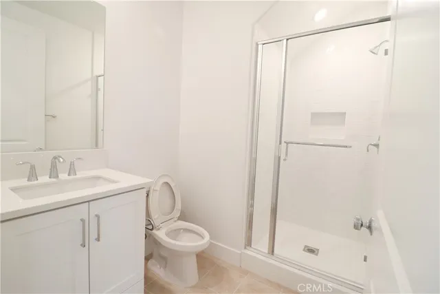 a bathroom with a shower a toilet and sink
