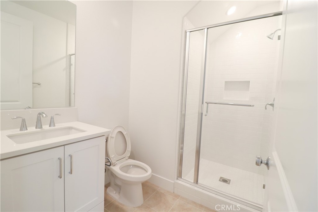 647 Gadwall Irvine, CA 92618 - Photo 10 of 29 a bathroom with a shower a toilet and sink