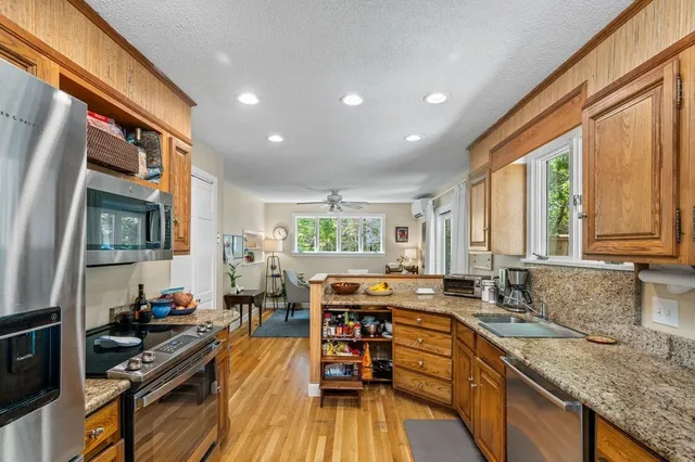 a kitchen with stainless steel appliances granite countertop a stove and a sink
