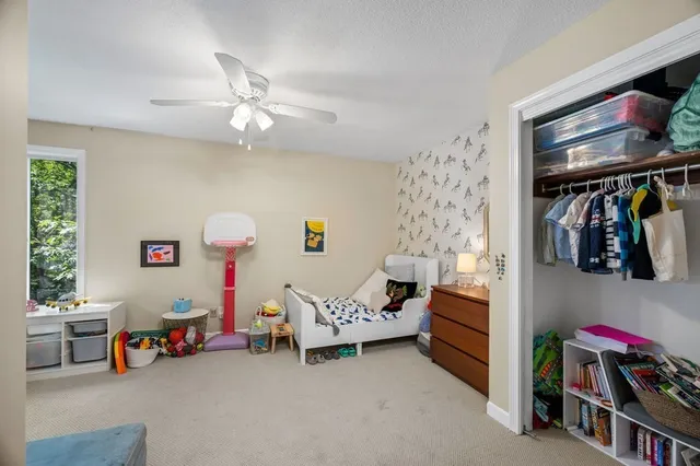 a bedroom with furniture and a fan
