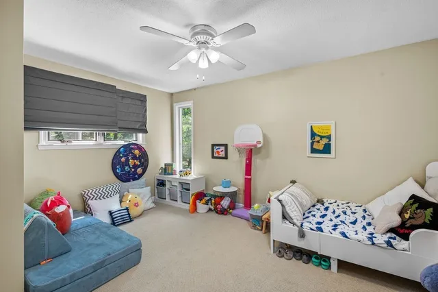 a bedroom with bed and a chandelier