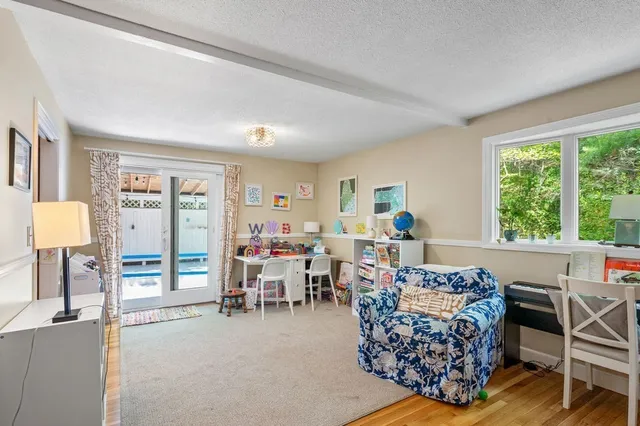 a living room with furniture a large window and a table