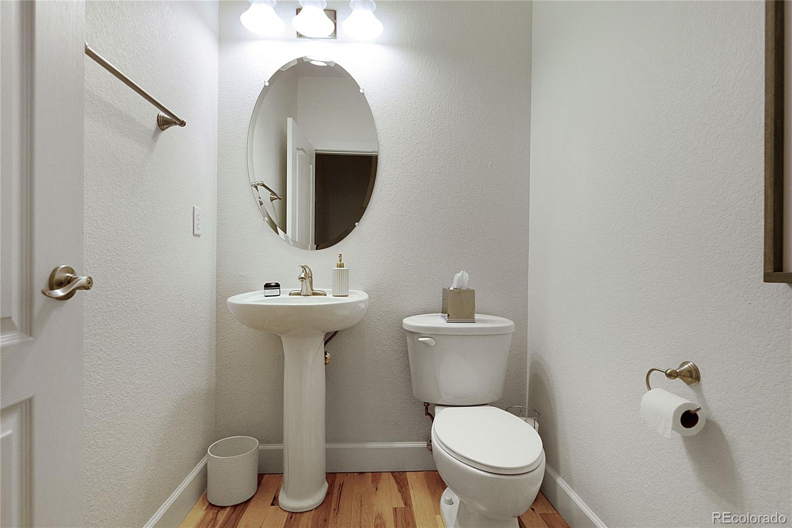 4511 Perry Street Denver, CO 80212 - Photo 12 of 36 a bathroom with a toilet sink and mirror