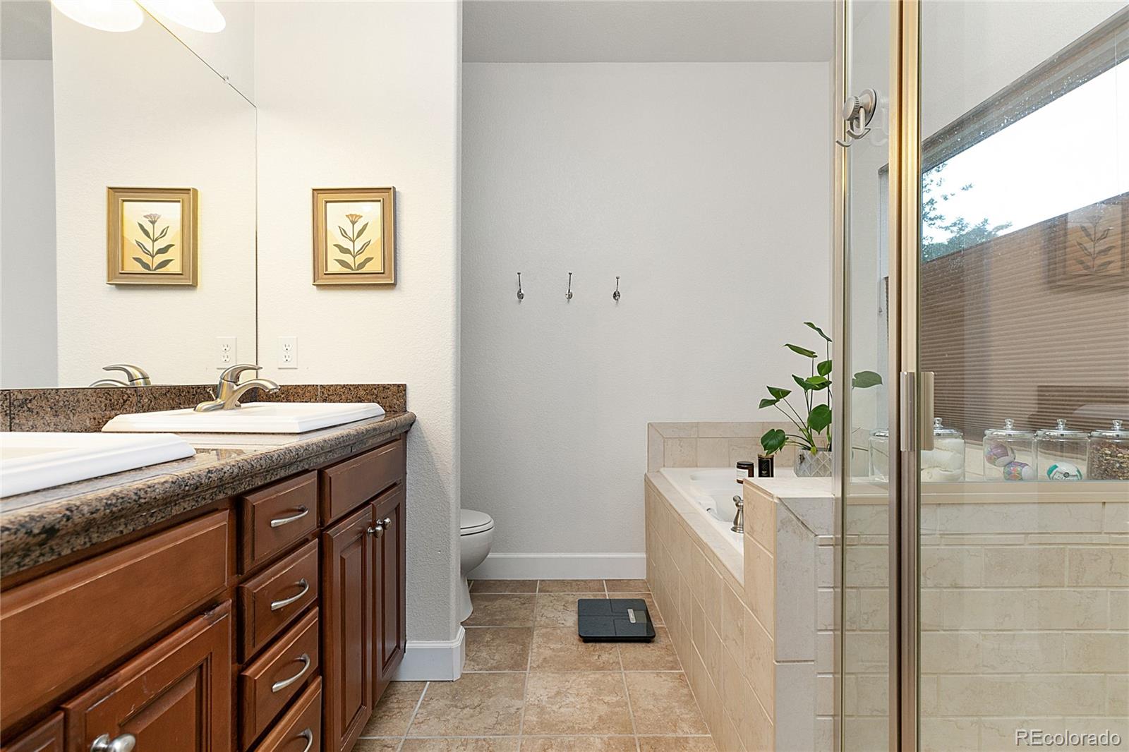 4511 Perry Street Denver, CO 80212 - Photo 16 of 36 a bathroom with a granite countertop sink a toilet and shower