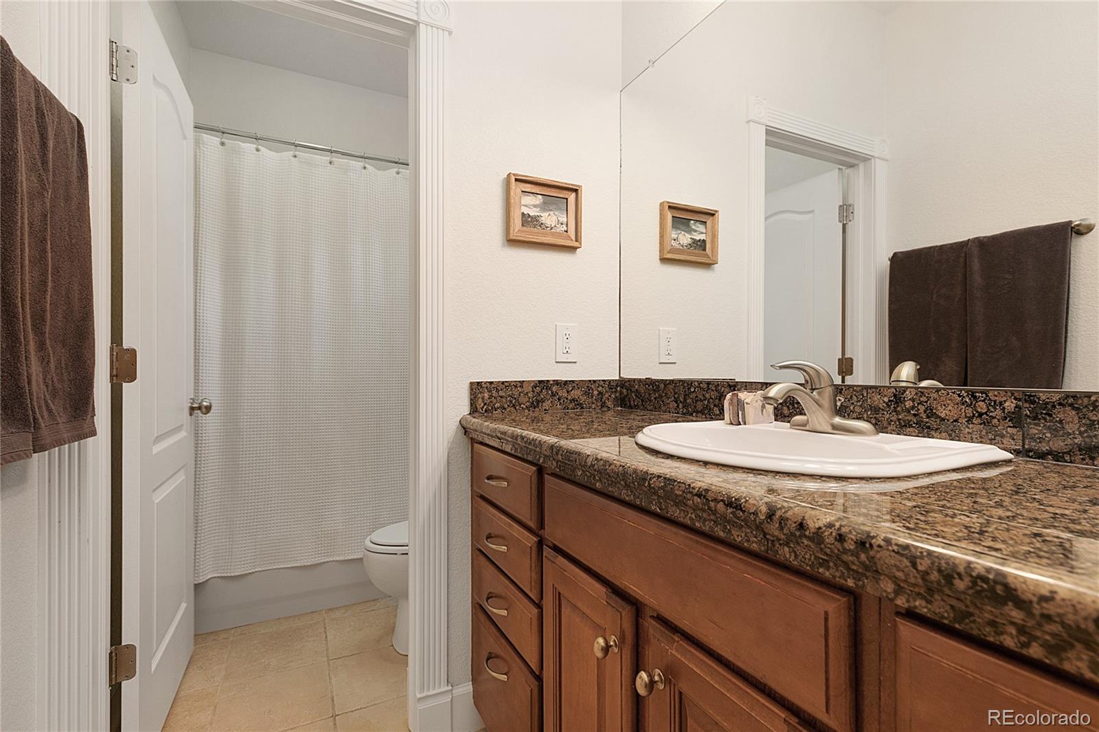 4511 Perry Street Denver, CO 80212 - Photo 18 of 36 a bathroom with a granite countertop sink and a mirror