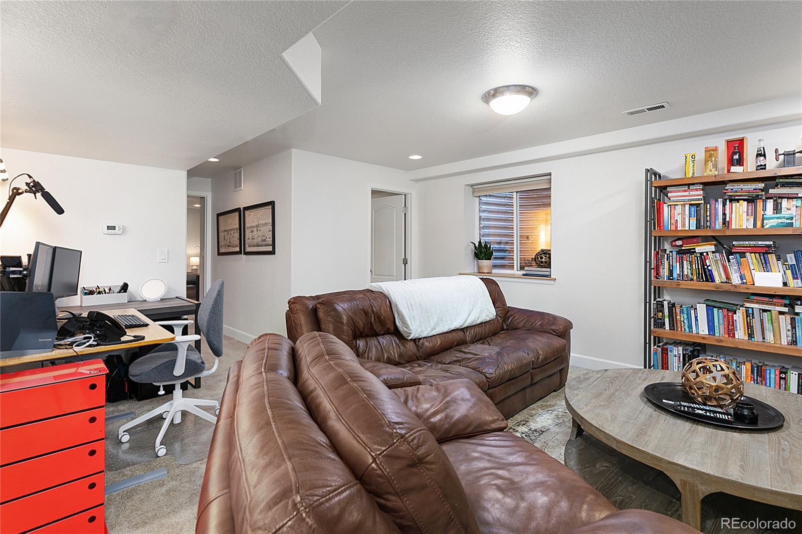 4511 Perry Street Denver, CO 80212 - Photo 21 of 36 a living room with furniture and a book shelf