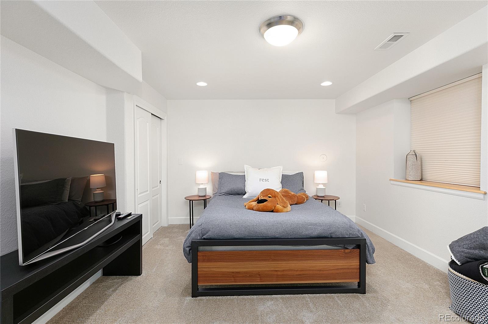 4511 Perry Street Denver, CO 80212 - Photo 22 of 36 a bedroom with furniture and a flat screen tv