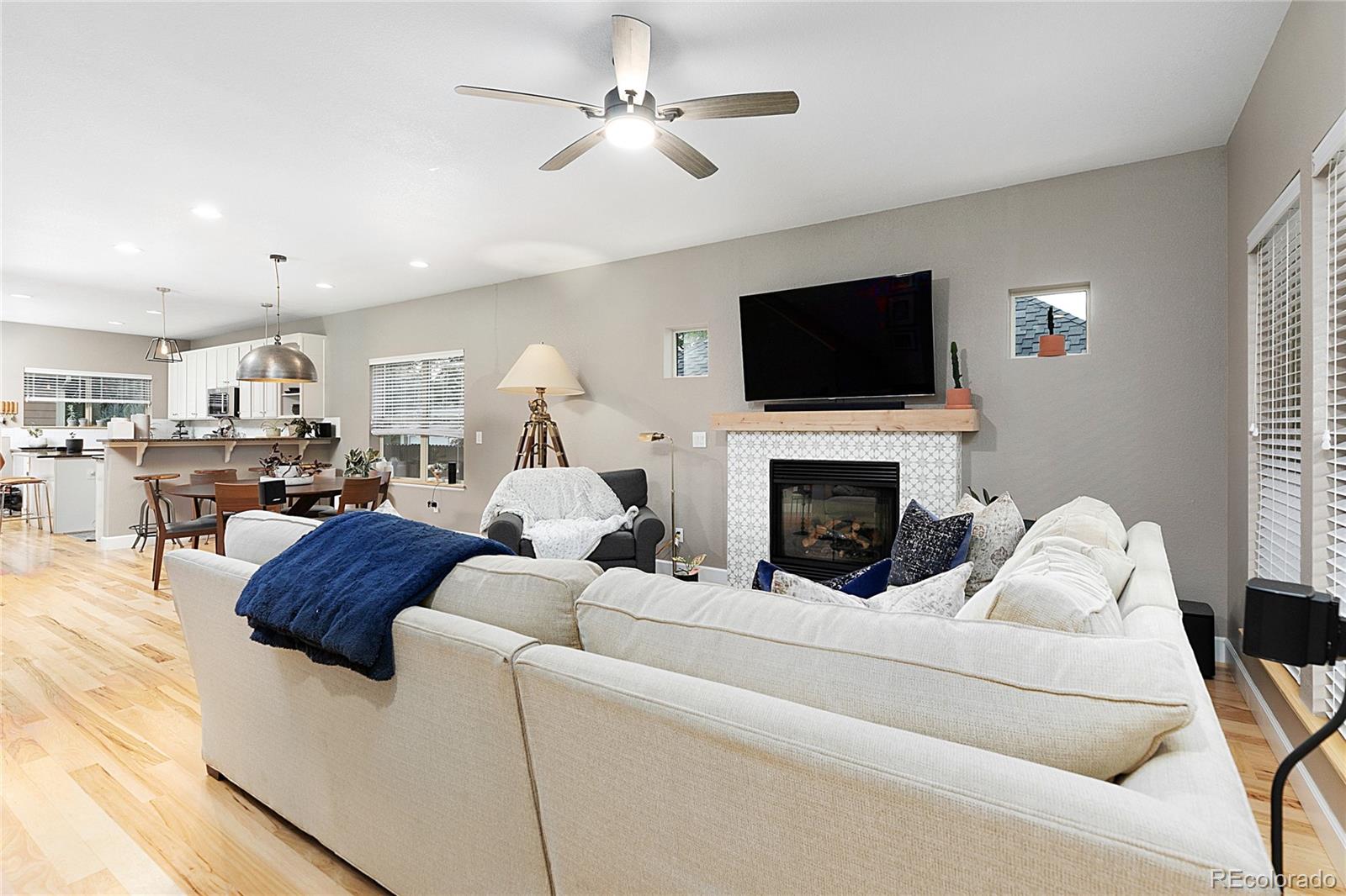 4511 Perry Street Denver, CO 80212 - Photo 4 of 36 a living room with furniture a flat screen tv and a fireplace