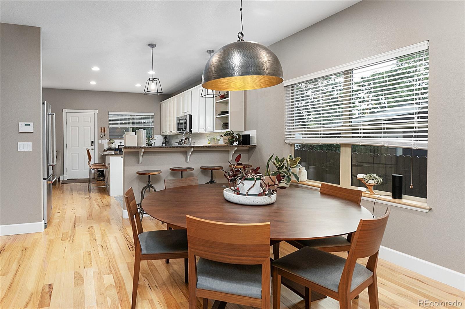 4511 Perry Street Denver, CO 80212 - Photo 6 of 36 a view of a dining room with furniture and wooden floor