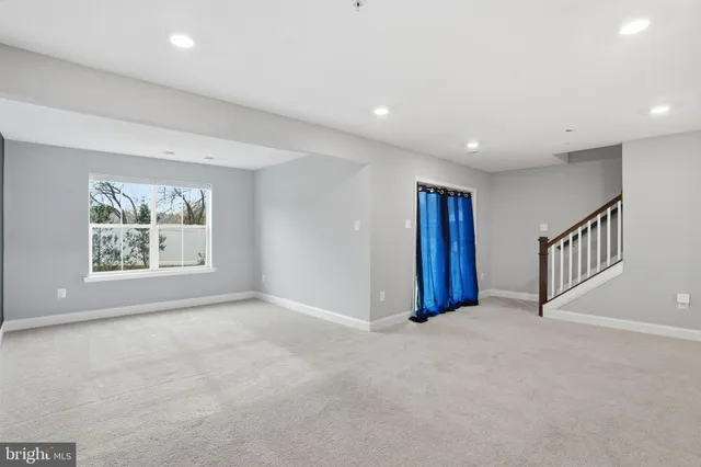 an empty room with windows and closet