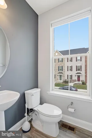 a white toilet sitting next to a bathroom sink