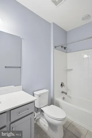 a white toilet sitting next to a bath tub