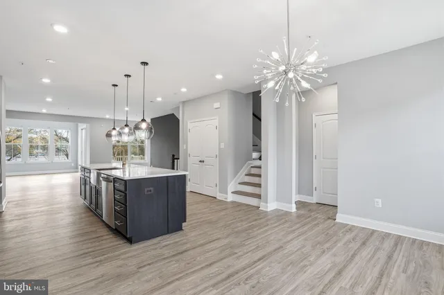 a view of kitchen with cabinets and wooden floor