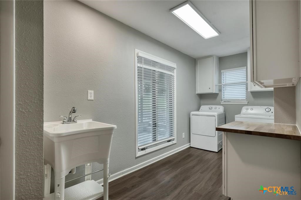 1529 North Colorado Street Lockhart, TX 78644 - Photo 13 of 14 Oversized utility room with sink and windows for natural light
