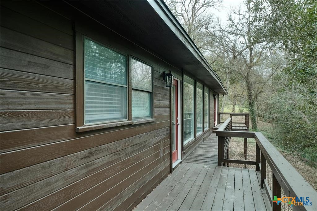 1529 North Colorado Street Lockhart, TX 78644 - Photo 14 of 14 Back deck along the whole back of the house with view of the dry creek bed and trees