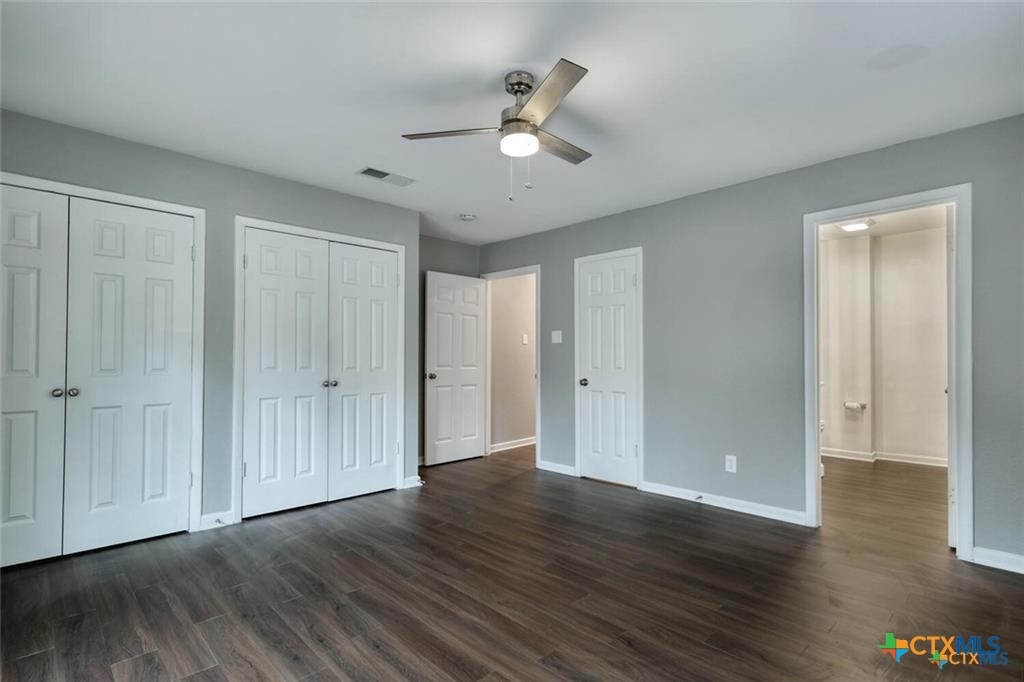 1529 North Colorado Street Lockhart, TX 78644 - Photo 7 of 14 Primary bedroom with ceiling fan and hard surface flooring.