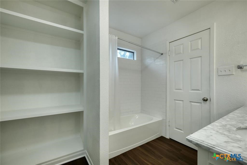 1529 North Colorado Street Lockhart, TX 78644 - Photo 9 of 14 Primary full bath with built int shelving