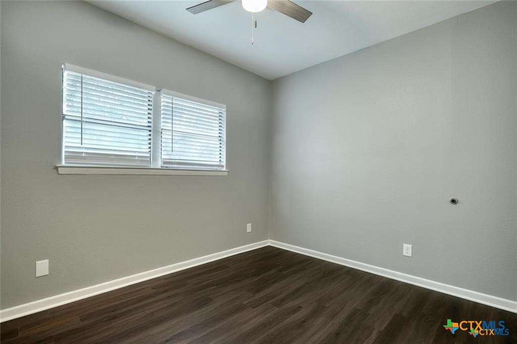 1529 North Colorado Street Lockhart, TX 78644 - Photo 10 of 14 second bedroom with hard surface flooring, ceiling fan, and window for natural light