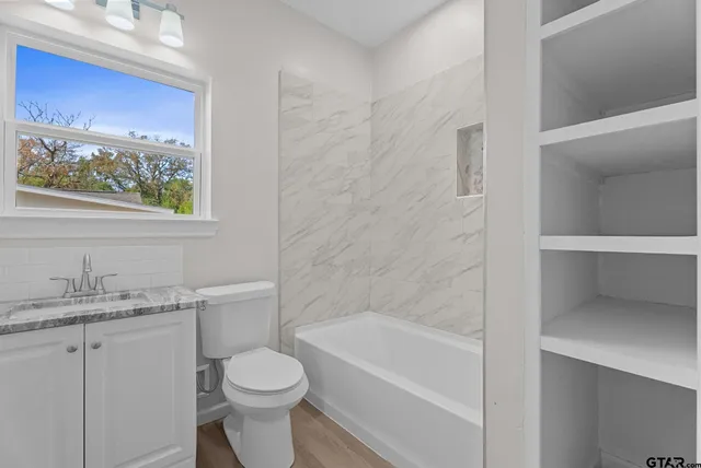 a bathroom with a sink toilet and bathtub