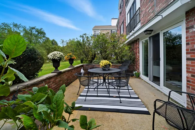 a view of a chairs and table in patio