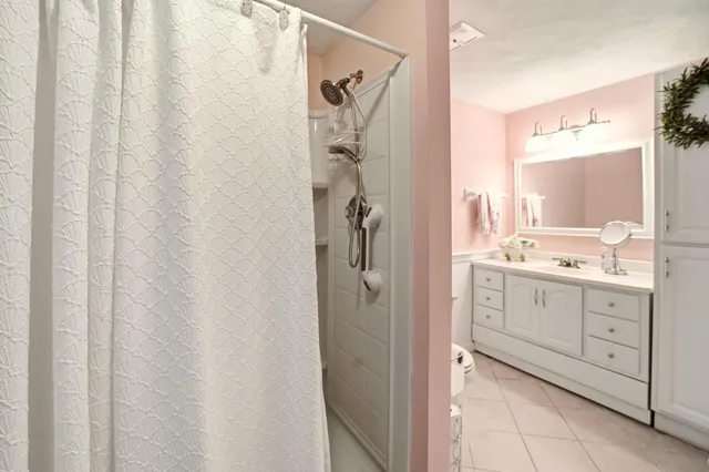 a bathroom with a sink a mirror and a shower