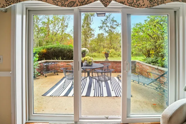 a view of a room with a large window and yard