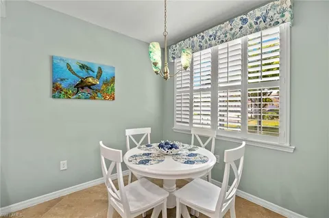 a view of a dining room with furniture and window