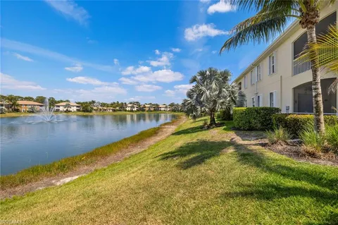 a view of a lake with houses in the back