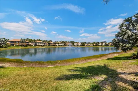 a view of a lake with houses in the background
