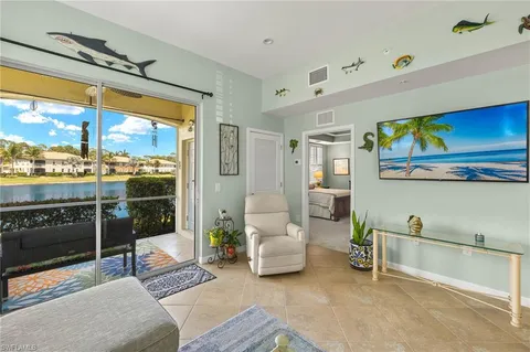 a living room with furniture a rug and a window