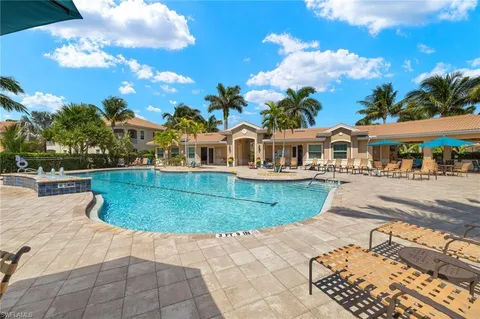 a view of a white house with a swimming pool