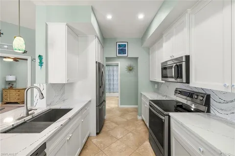 a kitchen that has a sink and a stove