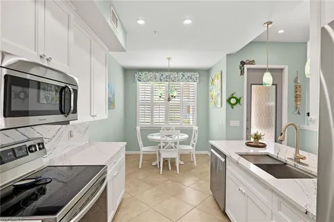 a kitchen with a stove a sink and a microwave