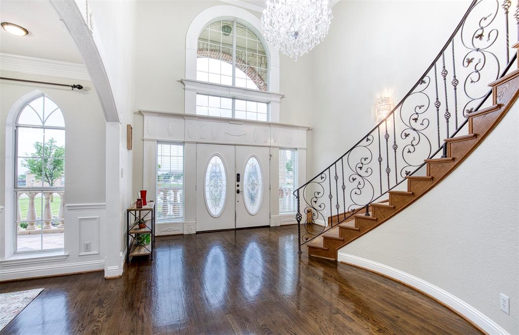 a view of entryway with wooden floor and a front door