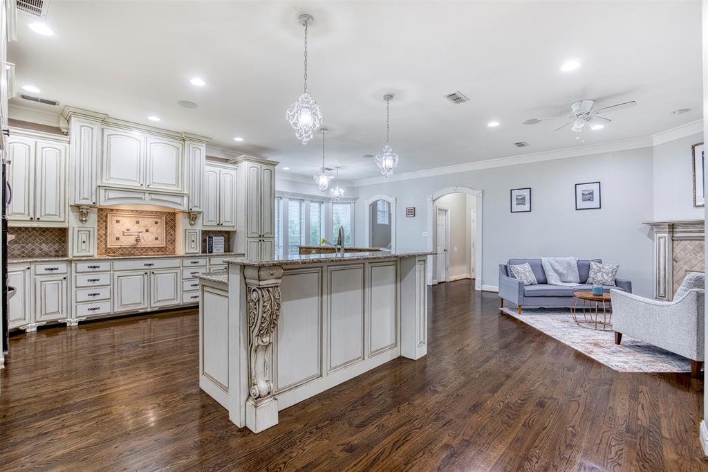 124 Lonesome Trail Haslet, TX 76052 - Photo 15 of 40 a large white kitchen with lots of counter space wooden floor and appliances