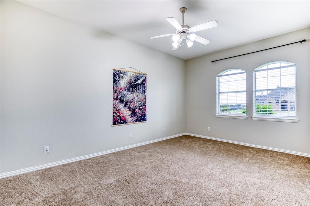 124 Lonesome Trail Haslet, TX 76052 - Photo 23 of 40 an empty room with windows and fan