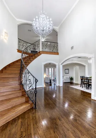 a view of a livingroom with fireplace dining space and chandelier