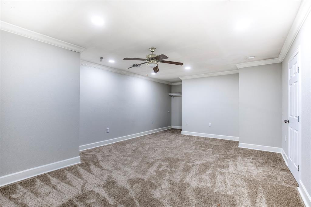 124 Lonesome Trail Haslet, TX 76052 - Photo 27 of 40 an empty room with a ceiling fan and carpet