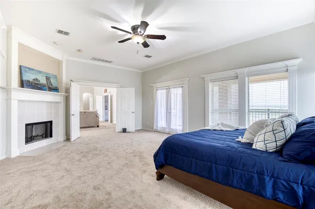 a bedroom with a large bed and a fireplace