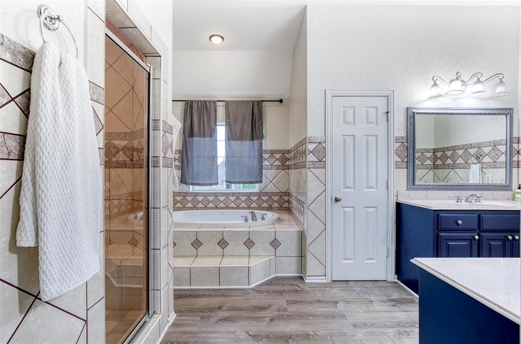 124 Lonesome Trail Haslet, TX 76052 - Photo 32 of 40 a spacious bathroom with a tub shower and sink