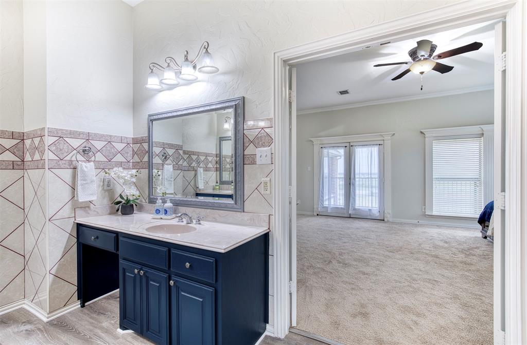 124 Lonesome Trail Haslet, TX 76052 - Photo 33 of 40 a bathroom with a sink vanity and a mirror