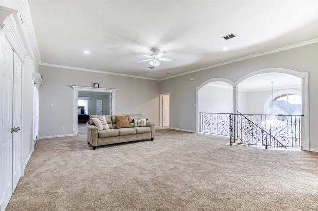 a living room with furniture white walls and a chandelier
