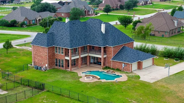 an aerial view of a house with swimming pool garden and outdoor seating