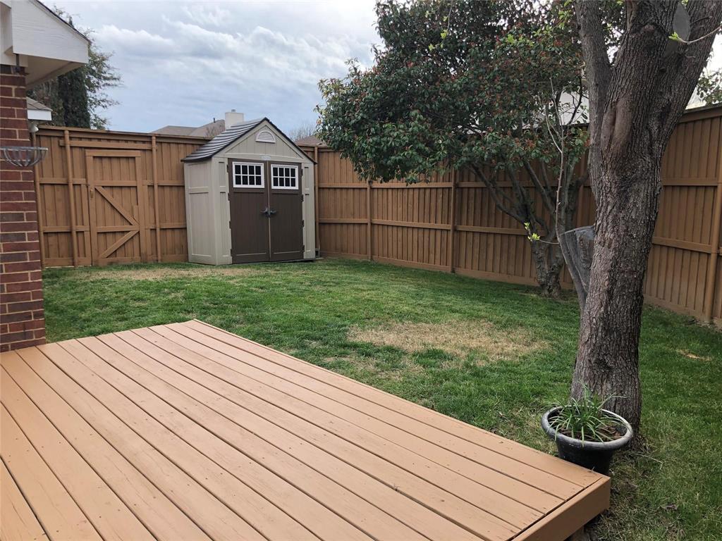 8301 Bells Street Frisco, TX 75035 - Photo 22 of 24 a view of a backyard with wooden floor and fence